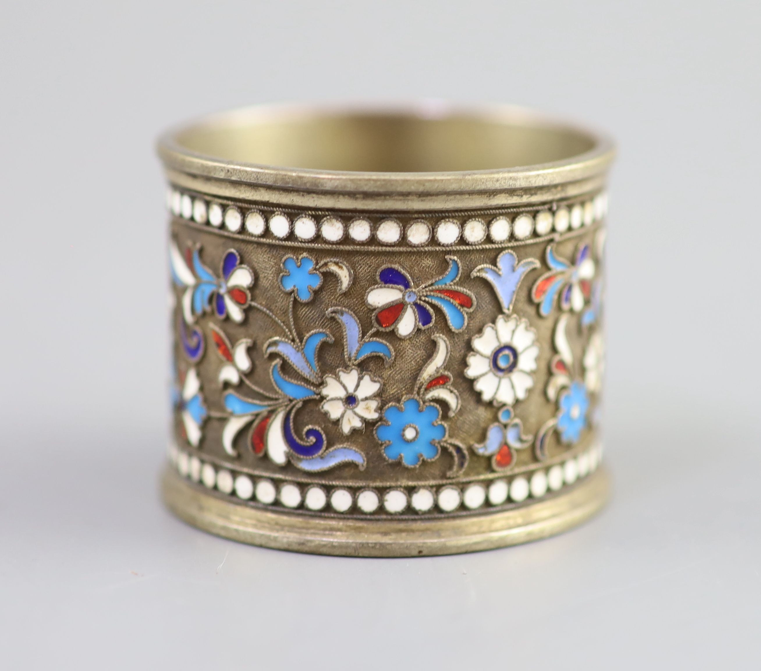 Five assorted late 19th/early 20th century Russian 84 zolotnik silver gilt and cloisonne enamel spoons and a similar napkin ring